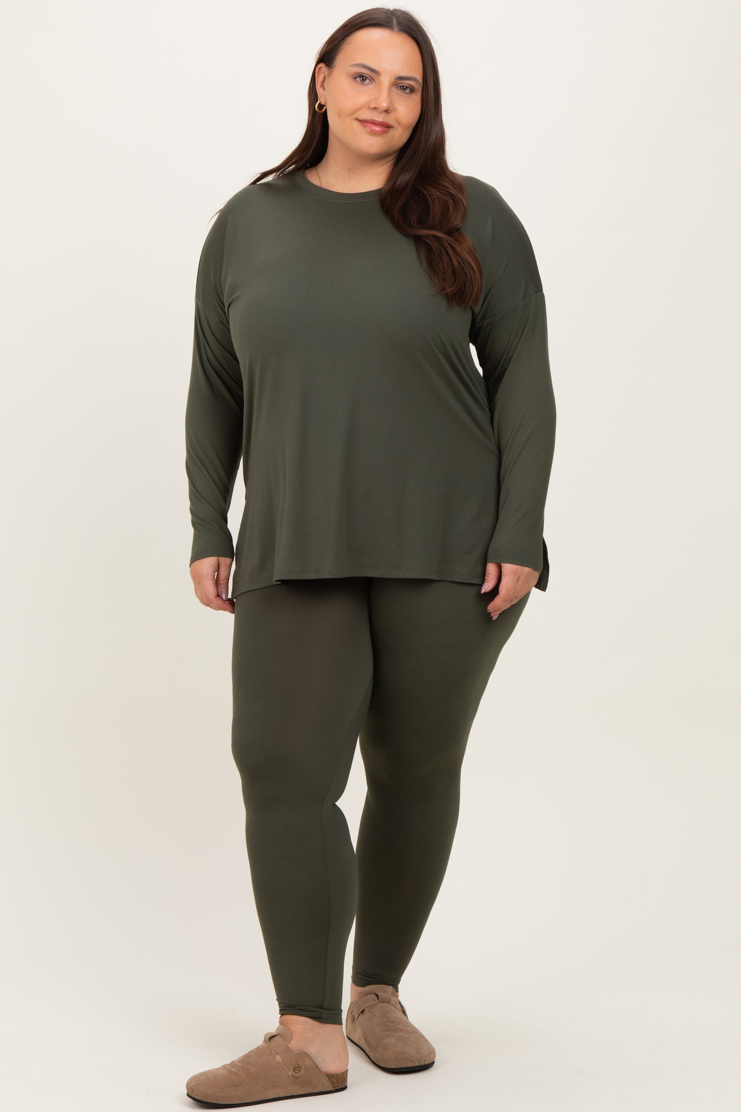 woman wearing an olive green long sleeve top and matching leggings in plus size