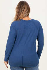 woman wearing a navy blue long sleeve maternity top with a ribbed texture and back seam details