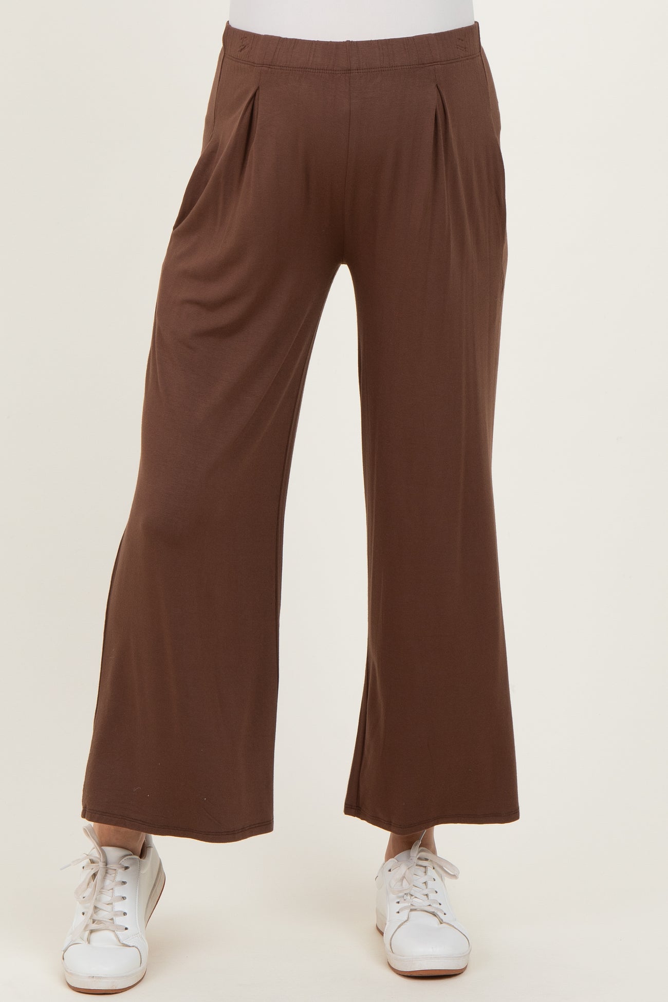 maternity wear brown wide leg pants with pleats, styled with white sneakers