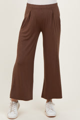 maternity wear brown wide leg pants with pleats, styled with white sneakers