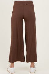 maternity wear brown wide-leg pants viewed from the back, styled with white sneakers