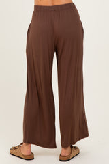 woman wearing brown wide-leg pants with side pockets, viewed from the back