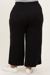woman wearing black wide-leg plus size pants with elastic waistband, viewed from the back
