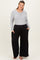 woman wearing a light gray long sleeve maternity top and black wide-leg maternity pants with pockets