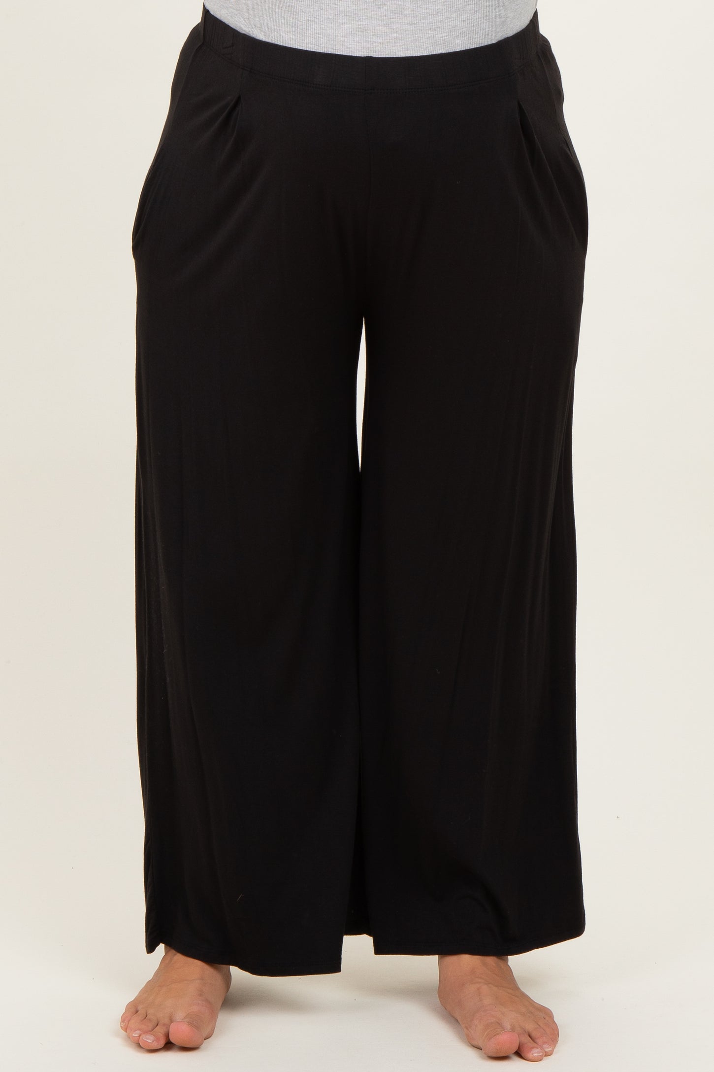 maternity plus black wide leg pants with side pockets, model wearing them barefoot