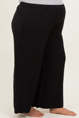 woman wearing black maternity plus wide-leg pants with a comfortable fit and side pockets