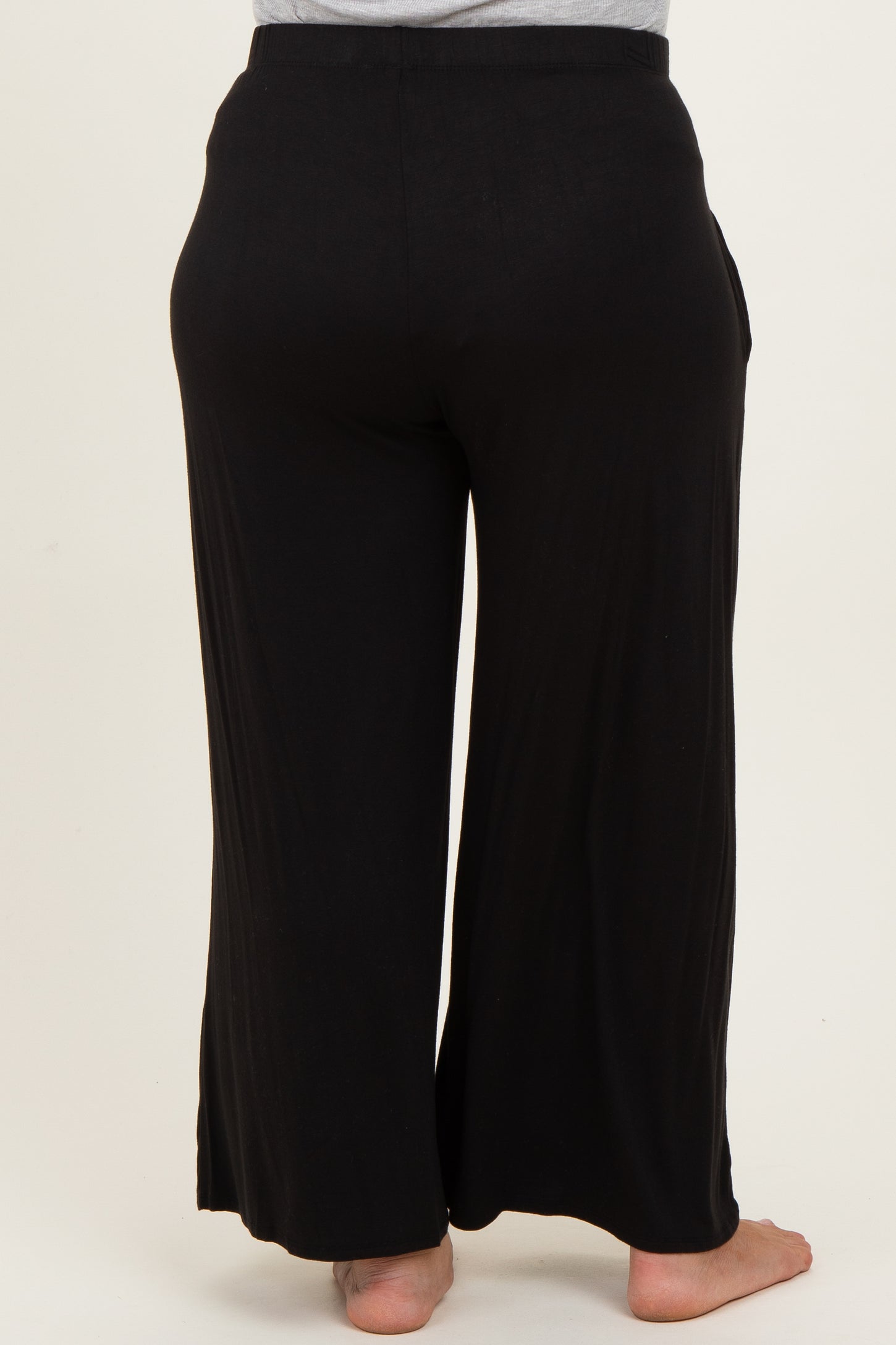 maternity plus black wide-leg pants with pockets shown from the back