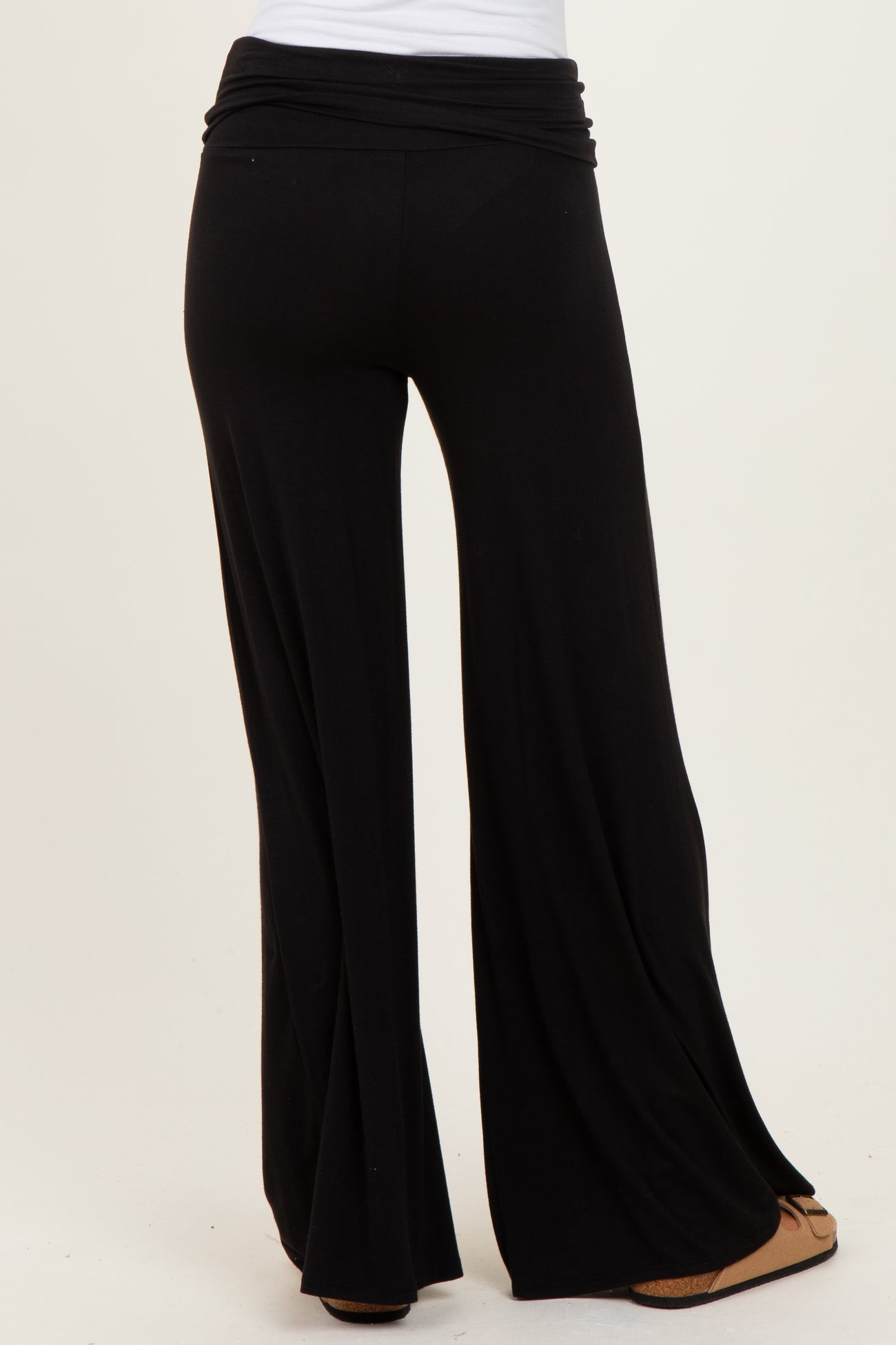 black wide-leg trousers with a high waistband shown from the back