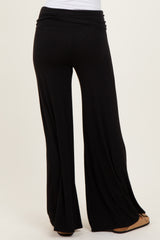 black wide-leg trousers with a high waistband shown from the back