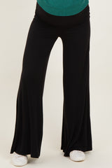 woman wearing black maternity wide-leg pants with a comfortable waistband and relaxed fit