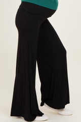 woman wearing a black maternity pant with a flowing silhouette and a visible baby bump