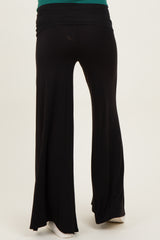 woman wearing black maternity wide-leg pants with a comfortable waistband, viewed from the back