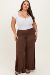 woman wearing a white short sleeve bodysuit and brown wide-leg pants