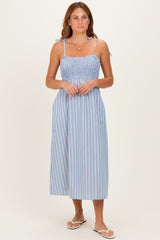 woman wearing a blue and white striped midi dress with smocked bodice and tie straps