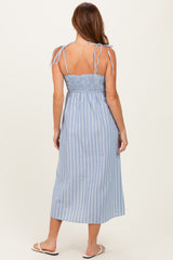 woman wearing a blue striped maxi dress with tie straps and a smocked back