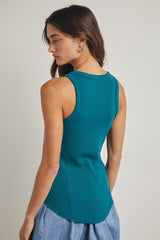woman wearing a teal ribbed tank top with a rounded hem and a fitted silhouette