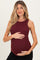 woman wearing a burgundy ribbed maternity tank top and holding her baby bump