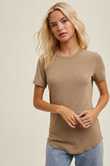 woman wearing a light brown short sleeve ribbed top with a round neckline and a relaxed fit.