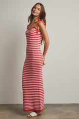 woman wearing a red and white striped sleeveless maxi dress with tie straps and a fitted silhouette