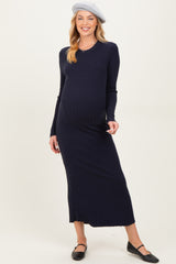 woman wearing a navy ribbed maternity maxi dress and a beret, showcasing her baby bump