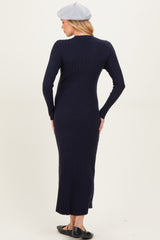 woman wearing a navy blue ribbed maternity dress with long sleeves and a fitted silhouette, viewed from the back