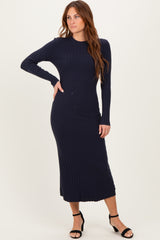 woman wearing a navy ribbed long sleeve midi dress with a fitted silhouette and button details
