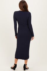 woman wearing a navy ribbed long sleeve midi dress, showing a fitted silhouette and back view