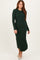 woman wearing a long green ribbed knit dress with long sleeves and a fitted silhouette