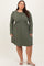 woman wearing a long sleeve olive green striped plus size dress with a flared skirt and a rounded neckline
