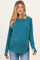 woman wearing a teal ribbed maternity top with long sleeves and a relaxed fit, showcasing her baby bump