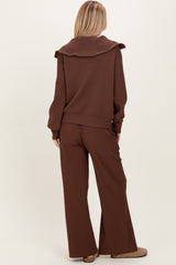 woman wearing a brown ribbed two-piece set with a wide-collared top and matching wide-leg pants