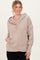 woman wearing a beige hooded sweatshirt with button details and a front pocket