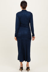 woman wearing a navy blue long sleeve shimmer maxi dress with ruching details and a fitted silhouette