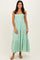 woman wearing a mint green strapless tiered maxi dress with a flowy silhouette