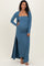 woman wearing a teal ribbed maternity maxi dress with a long cardigan and showing her baby bump