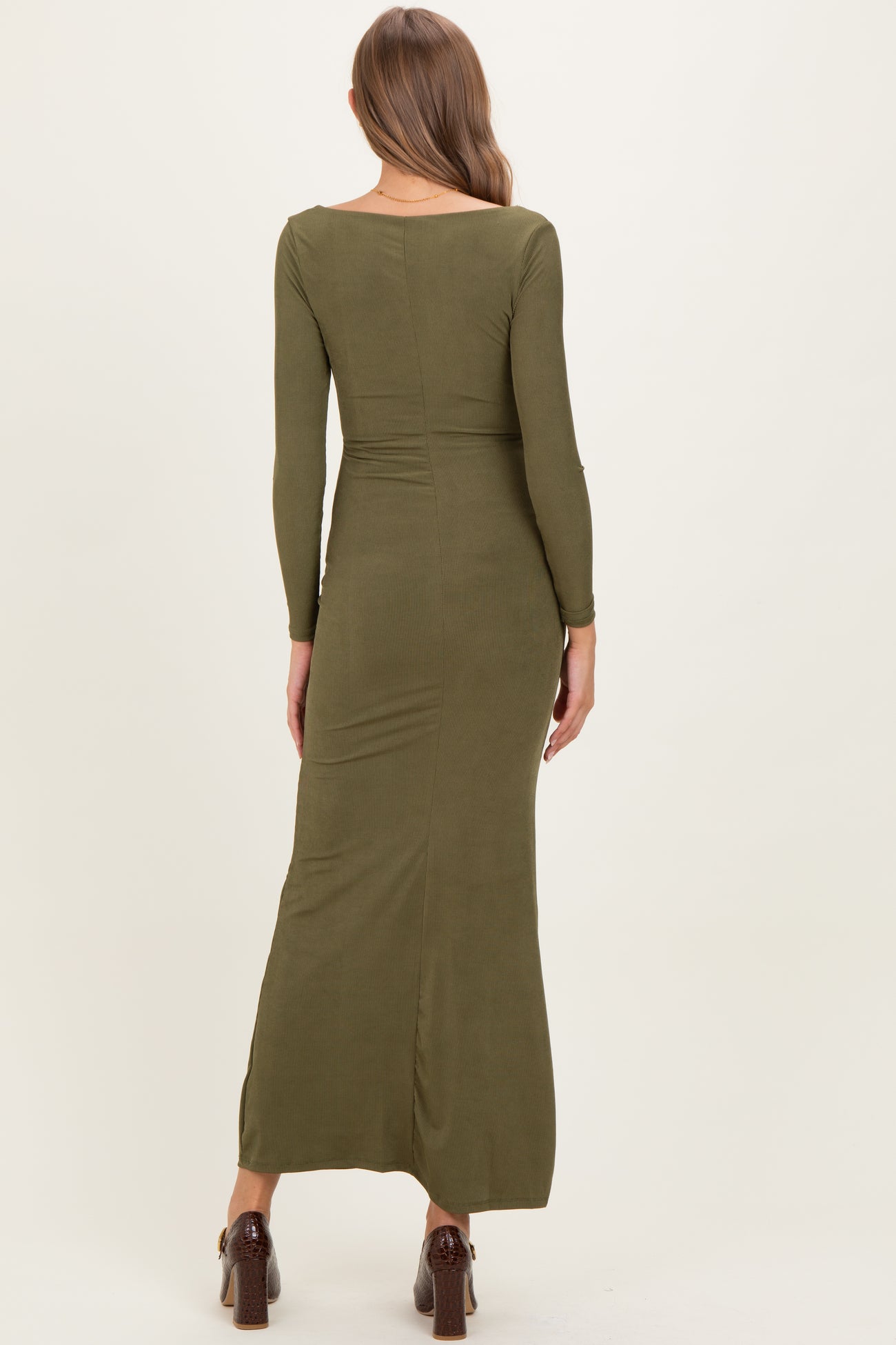 woman wearing an olive green long sleeve maternity dress, shown from the back with a form-fitting silhouette