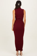 woman wearing a burgundy sleeveless ribbed maxi dress with a high neck and fitted style from the back
