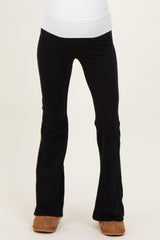 woman wearing black maternity leggings with a wide waistband