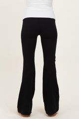 woman wearing black maternity flared pants, back view, fitted through the hips and flaring out at the hem