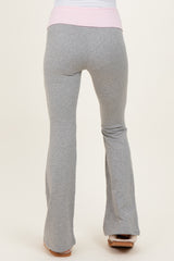 woman wearing gray maternity flared sweatpants with a pink waistband from the back