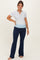 woman wearing a gray short sleeve henley top and navy blue maternity yoga pants with a light blue waistband