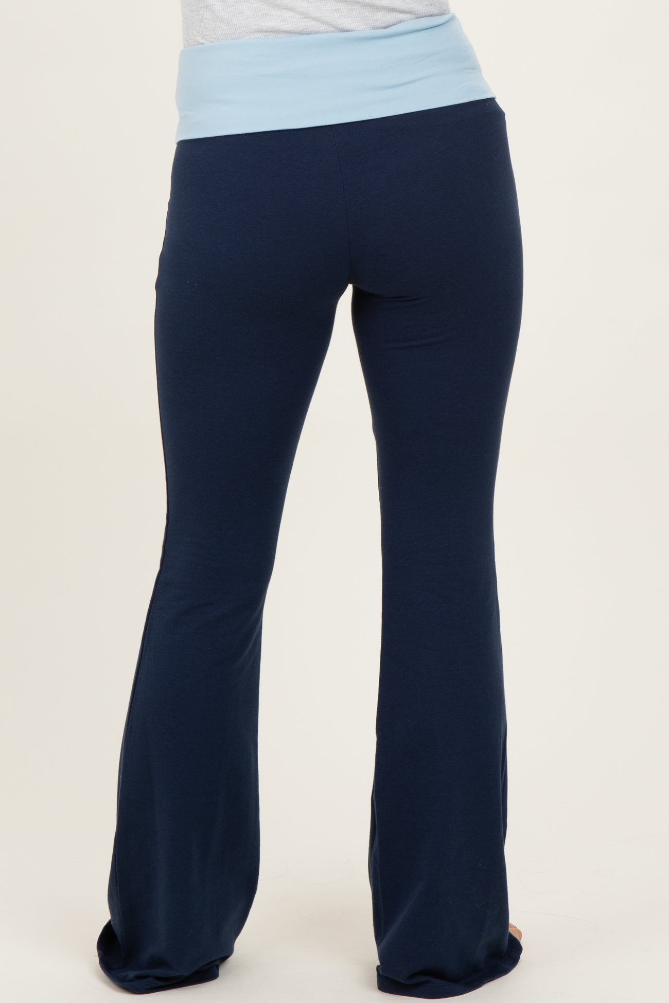 maternity wear navy blue flare pants with a light blue waistband, model shown from the back