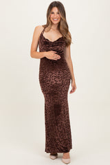 woman wearing a brown leopard print maternity maxi dress with a cowl neckline and cradling her baby bump