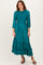 woman wearing a teal pleated midi dress with a smocked bodice and ruffle hem, paired with black strappy heels