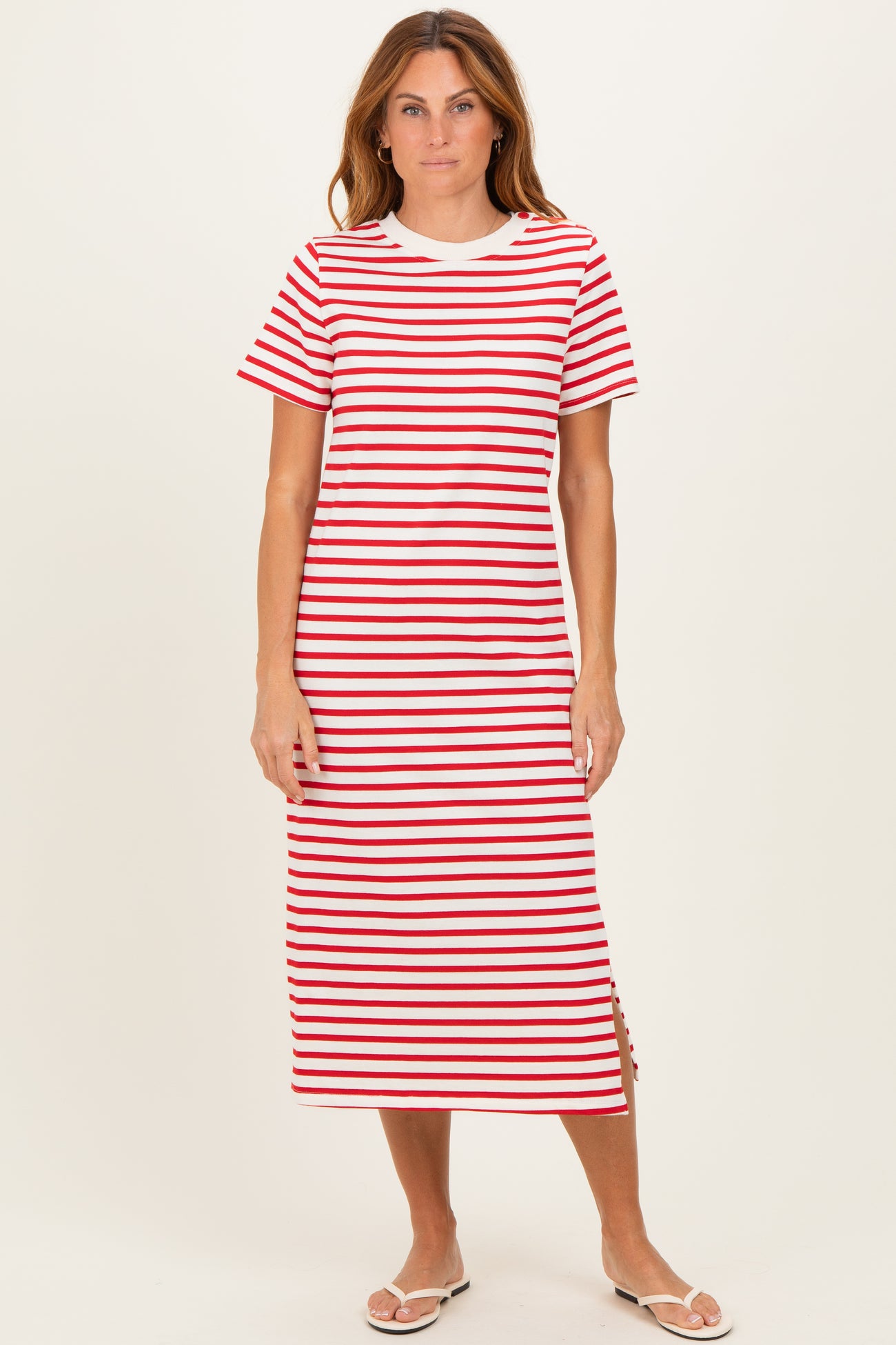 woman wearing a red and white striped midi t-shirt dress with short sleeves and side slits