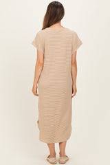 woman wearing a beige maternity wrap dress with short sleeves and side slits, shown from the back