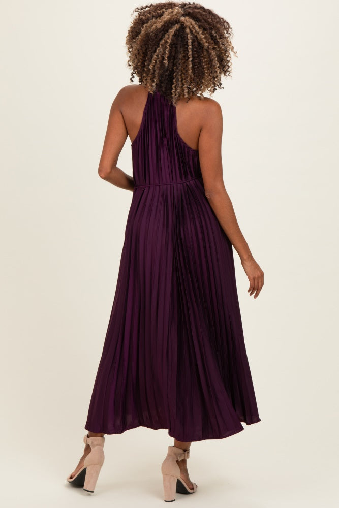 woman wearing a purple pleated maternity maxi dress, showing the back view and style details