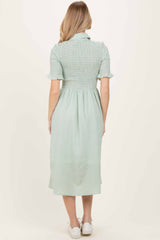 woman wearing a green checkered smocked midi dress with short sleeves, seen from the back