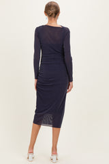 woman wearing a navy blue long sleeve maternity dress with a fitted silhouette and mid-length hem