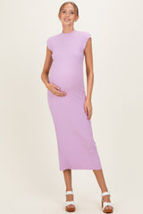 woman wearing a light purple ribbed maternity dress, holding her baby bump with a smile